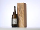 a bottle of wine sitting next to a wooden box