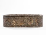 an antique brass box with a floral design on the lid