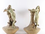 pair of statues of a woman and a man on a tree stump