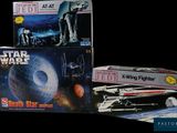 three star wars action figures and a box of star wars toys