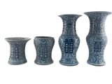 three blue and white vases sitting next to each other on a white surface
