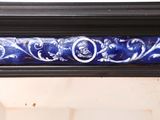 a mirror with a blue and white design on it