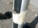 a metal pole with a piece of tape on it