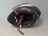a helmet that is sitting on the floor with a cord attached to it