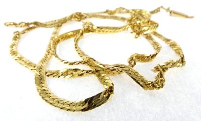 gold plated necklace with twisted rope design on a white background