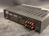 a close up of a black amplifier on a gray surface