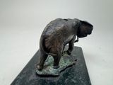 a statue of an elephant that is standing on a marble base