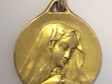 a close up of a gold medal with a woman ' s face on it