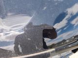 a reflection of a man in the mirror of a car