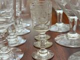 many wine glasses sitting on a table in a room