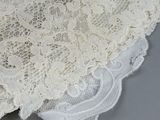 a close up of a piece of lace on a piece of cloth