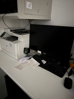 a computer on a desk with a printer on it