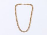 a close up of a gold chain necklace on a white background