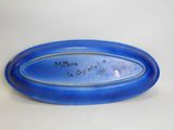 a blue plate with a name on it on a table