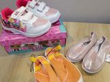 three pairs of shoes sitting on a table next to a box