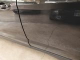 a close up of a car door with a hole in the side