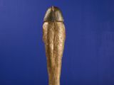 a gold statue of an egyptian pharaoh standing on a white surface