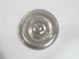 a metal object on a white surface that looks like a spiral