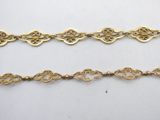 a set of three gold chain bracelets on a white background