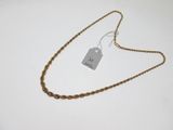a close up of a gold chain with a tag on it