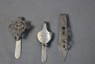 three silver spoons and a silver spoon with a bird on it