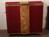 a red suitcase with a gold stripe on it