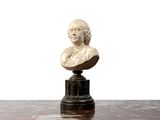a marble bust of a woman sitting on a table