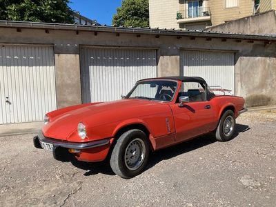 a red sports car parked in front of a garage