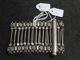 a silver bracelet that has a bunch of beads on it