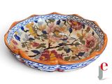 a bowl with a floral design on it on a white surface