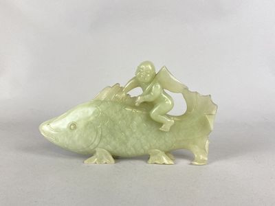 une figurine représentant un homme chevauchant un poisson
