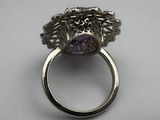 an image of a silver ring with a purple stone in it