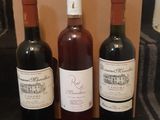 trois bouteilles de vin posées l'une à côté de l'autre sur une table