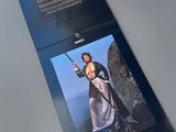 an image of a brochure with a picture of a woman holding a sword