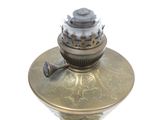 a small antique brass oil lamp on a white background