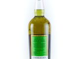 a bottle of olive oil sitting on top of a white surface