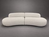 the curved sofa is made out of fabric and has a rounded shape
