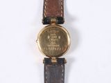 a watch that is sitting on a white surface