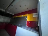 a picture of a kitchen with a red and yellow wall