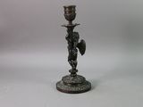 an image of a bronze candle holder with a bird on it
