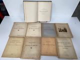 several old books sitting on top of a white table next to each other