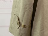 a close up of a person ' s jacket with buttons on it