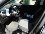 the interior of a small car with a steering wheel and dashboard