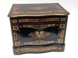 an image of a black and gold chest with a floral decoration