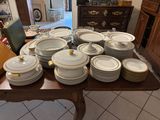 a lot of plates and bowls on the table