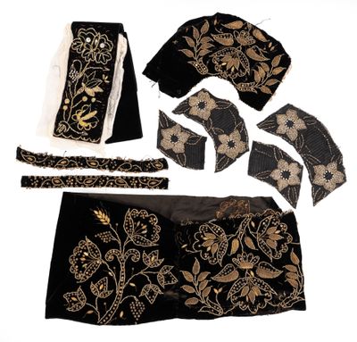 an image of a black and gold dress and accessories on a white background