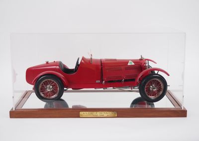 an old model of a red car in a clear display case
