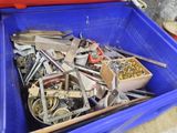 a blue container filled with assorted metal items