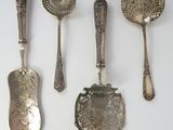 five spoons and two spoons on a white surface