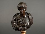 a bronze bust of a woman holding a baby on a marble base